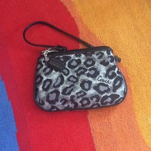 Purple & black Cheetah print Coach wristlet.